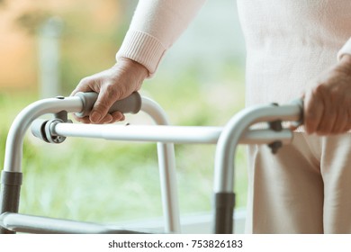 Close up of senior person using a walker during rehabilitation at home