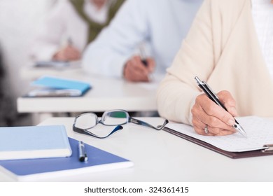 Close Up Of Senior Students During Written Exam