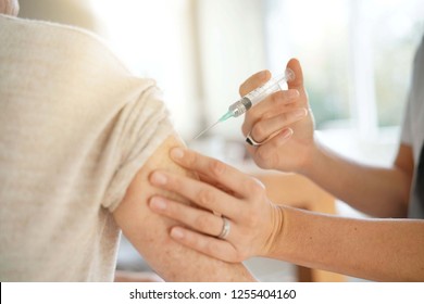 Close Up Of Senior Woman Geting Flu Shot                              