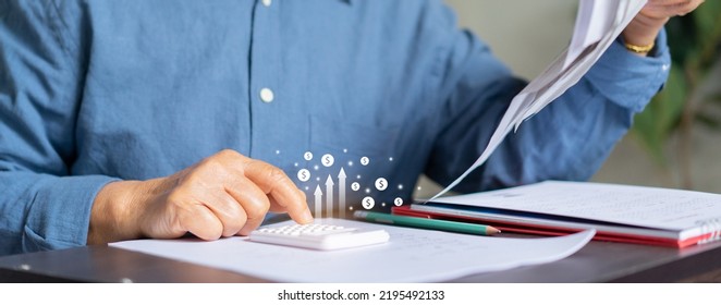 close up senior woman hand use calculator for counting about expenses monthly or spending money with virtual icon in living room for financial and economy lifestyle concept - Shutterstock ID 2195492133