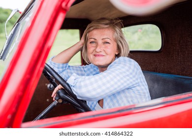 Close Up Of Senior Woman Inside Vintage Pickup Truck