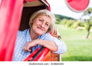 Close Up Of Senior Woman Inside Vintage Pickup Truck