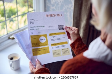 Close Up Of Senior Woman Opening Euro Energy Bill Concerned About Cost Of Living Energy Crisis