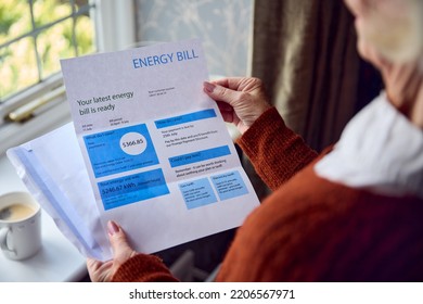 Close Up Of Senior Woman Opening UK Energy Bill Concerned About Cost Of Living Energy Crisis - Shutterstock ID 2206567971