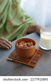 Close Up Senior Women Hand Holding A Bowl On Almond 