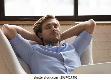 Close Up Serene Peaceful 30s Man Relaxing Lean On Cozy Armchair With Laptop. Guy Accomplish Telecommute, Take Break In Leather Chair With Eyes Closed. Repose, No Stress, Modern Comfy Furniture Concept