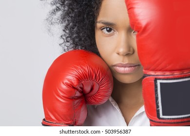 Close Up Of Serious African American Woman's Head With Her Boxing Gloves Covering It. Concept Of Tough Business Competition