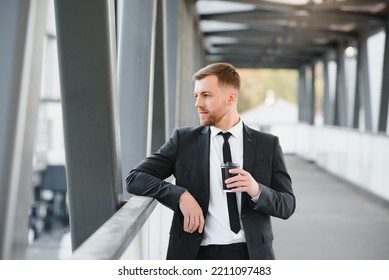 Close Up Serious Businessman Drinking Take Away Coffee At Street. Portrait Of Business Man Waiting With Coffee To Go Outdoor. Office Employee Looking Away At Street. Male Professional Take Break.