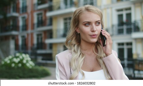 Close Up Serious Businesswoman Walking In Suit At Street. Stylish Business Woman Talking Phone Outdoors. Attractive Lady Calling On Mobile Phone Outside.