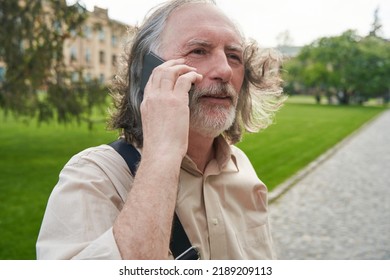 Close Up Of Serious Man Having Telephone Conversation