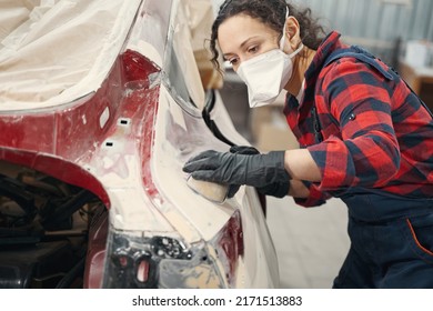 Close Up Of Serious Master Applying Primer On Car