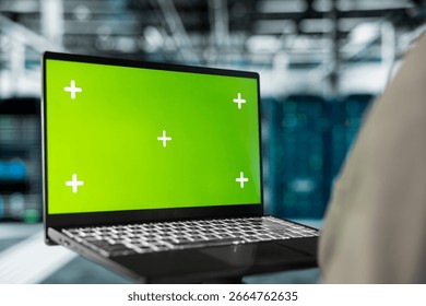 Close up of server hub engineer using mockup laptop to repair equipment storing datasets. IT professional using green screen notebook to do debugging on rigs doing computational operations