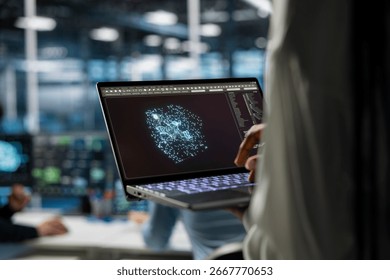 Close up of server hub worker optimizing performance through AI assistant analysis. Data center engineer using laptop to oversee supercomputers, speeding up tasks by following AI suggestions.