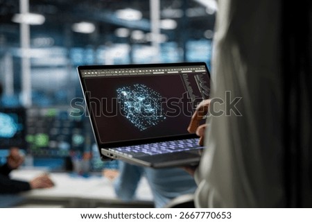 Close up of server hub worker optimizing performance through AI assistant analysis. Data center engineer using laptop to oversee supercomputers, speeding up tasks by following AI suggestions.