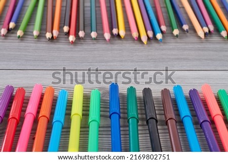 Close up set of colorful pens on grey desk. Felt-tip pens and pencils.