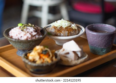 Close Up Of A Set Of Delicious Beef Burger Lunch Set, Served With Burger, Veggie Salad, Lotus Root, Red Bean Rice And Hot Soup. Focus On Beef Burger.