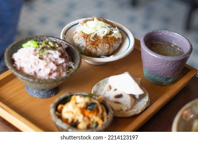 Close Up Of A Set Of Delicious Beef Burger Lunch Set, Served With Burger, Veggie Salad, Lotus Root, Red Bean Rice And Hot Soup. Focus On Beef Burger.