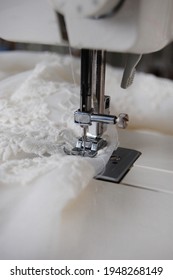 Close Up Of A Sewing Machine Making Alterations Of A Bride's Wedding Dress.