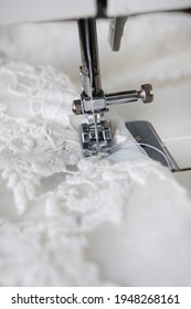 Close Up Of A Sewing Machine Making Alterations Of A Bride's Wedding Dress.