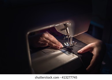 Close up of sewing machine on the table in the night. - Powered by Shutterstock