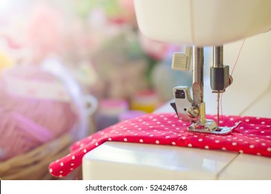 Close Up Of Sewing Machine Working With Red Fabric