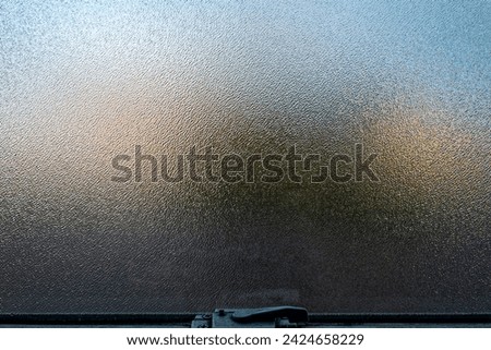 Close up of shadows and colors reflected on a frosted glass window