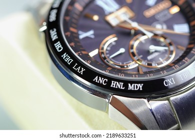 close up shallow focus Time zone cities code on luxury world time watch bezel on DEN Denver, LAX Los Angeles.