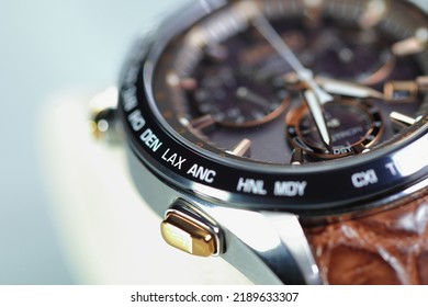 Close Up Shallow Focus Time Zone Cities Code On Luxury World Time Watch Bezel On LAX Los Angeles.