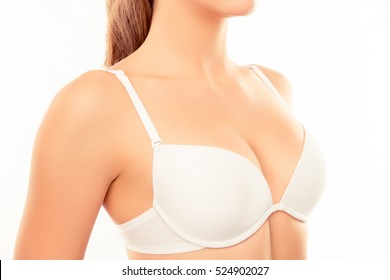 Close up of shapely sexy woman wearing white bra.