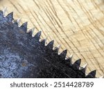 Close up of the sharp saw blade on the wooden board. Carpenter