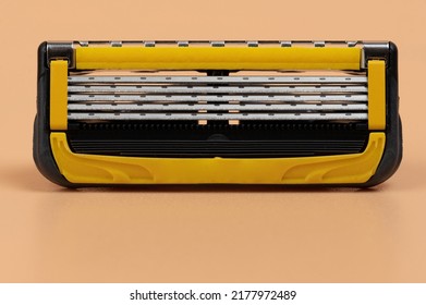 Close Up Of Shaving Razor Blade Cassette  Isolated On Brown Background