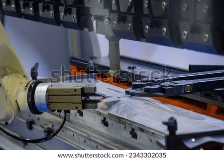 Close up the sheet metal bending process by robotic arm. The automatic material handling the sheet metal parts by robotic system. Foto stock © 