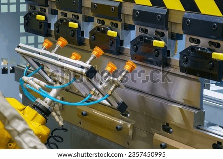 Close up the sheet metal bending process by robotic arm. The automatic material handling the sheet metal parts by robotic system. Foto stock © 