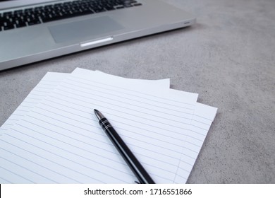 Close up of sheets, pen and computer