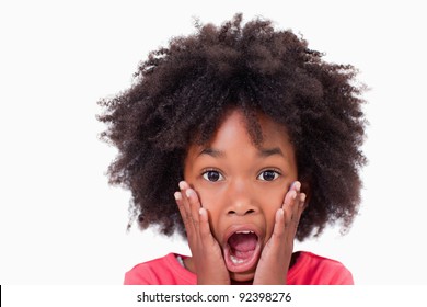 Close up of a shocked girl against a white background