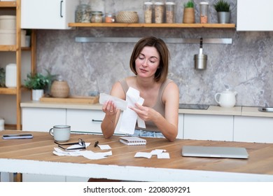 Close Up Of Shocked Woman Sitting At The Table, Stressed And Confused By Calculate Expense From Invoice Or Bills, Have No Money To Pay Mortgage Or Loan. High Prices And Spending Money Concept