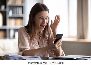 Close Up Shocked Young Woman With Wide Open Eyes And Mouth Looking At Phone Screen, Reading Unexpected News In Email Or Message, Excited By Money Refund, Great Shopping Offer, Job Promotion