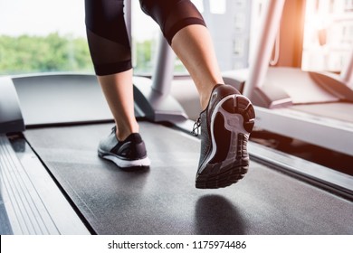 Close Up Shoes Foot Sneakers, Woman's Muscular Legs Feet During Running On Track Treadmill Exercise Workout In The Morning Time At Fitness Gym, Black And White Insole