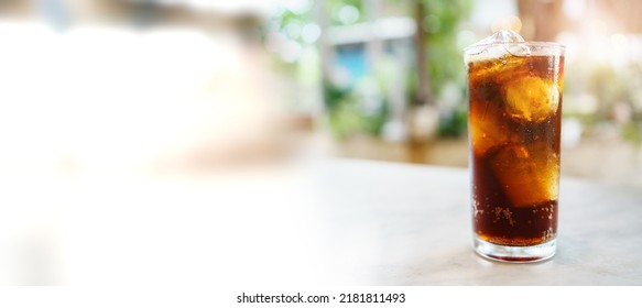 Close up shoot with copyspace of cola soda with ice in a drinking glass. Sparkling cola filled in the glass with ice. - Shutterstock ID 2181811493