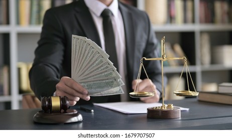 Close Up Shoot Of Lawyer Hand Holding Money In Court Room