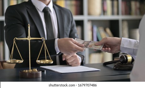 Close Up Shoot Of Lawyer Hand Receiving Money In Court Room