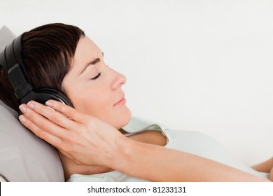 Close Up Of A Short-haired Woman Enjoying Some Music With Her Eyes Closed