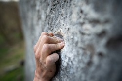 Close Up Shot Of An Adult Male Handholding On To A Rock, Illustration For Rock Climbing.