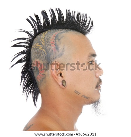 close up shot of asian punk's head with mohawk hair style, tattoo on head, ear and mouth piercing isolated on a white background