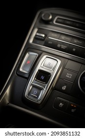 Close up shot of an automatic button gear shifter on a central console in a new car.