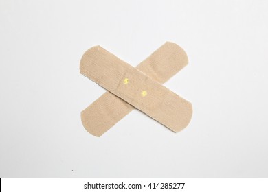 Close Up Shot Of A Bandaid Against Isolated White Background.