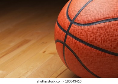 Close Up Shot Of A Basketball On A Hardwood Gym Floor