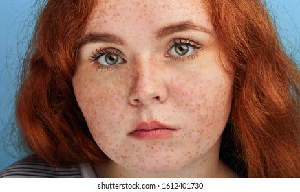 Close Up Shot Of Beautiful Girl With Ginger Hair And Freckles Looking At The Camera With Serious Expression, Beauty , People, Unusual Beauty