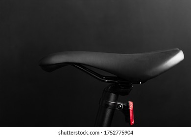 close up shot of the black bike saddle on the black background