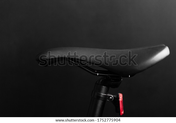 close up shot of the black bike saddle on the
black background